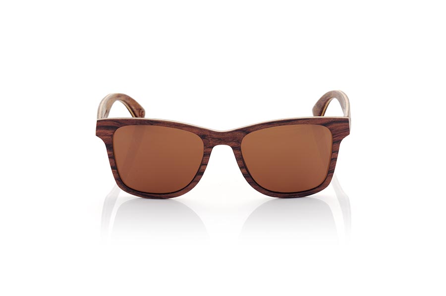 Wood eyewear of Rosewood MARIO. MARIO wooden sunglasses are a classic and timeless model that will perfectly complement any masculine look. Made entirely of laminated rosewood with a thin layer of maple interspersed, the combination of dark and light tones creates an elegant and subtle contrast. Fitting comfortably against the head, the temples are made from the same laminated wood for added durability. Classic styling and high-quality craftsmanship make these sunglasses a sophisticated and fashionable choice. Lenses available in solid shades of gray and brown provide full protection from the sun's rays. Front Measurement: 145x48mm Caliber: 52 for Wholesale & Retail | Root Sunglasses® 